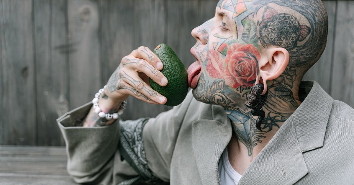 Who knows what this fruit is called? - Woman in Gray Coat Holding Green Round Fruit