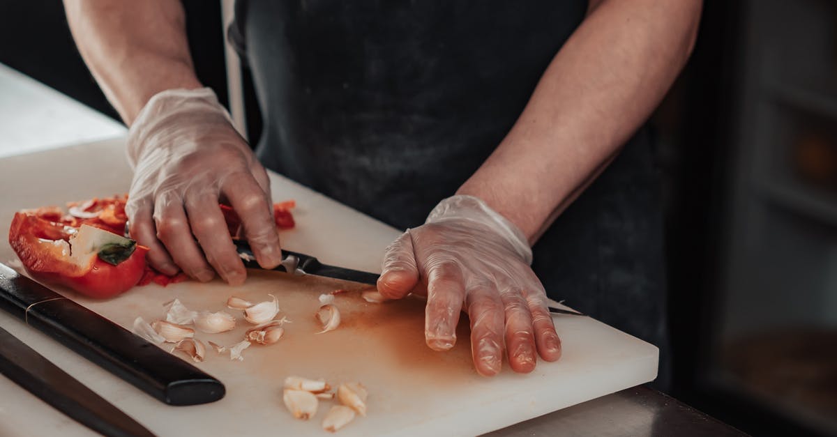Why are chef's knives wide? - Person Making a Dough on a White Table