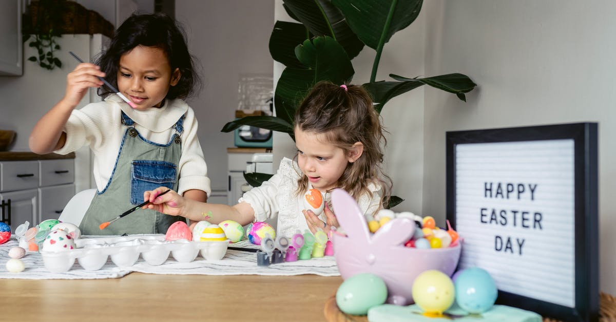 Why are croissants brushed twice with egg glaze? - Concentrated multiracial girls in casual outfits coloring Easter eggs with brushes near wooden table with various decorative objects in bright kitchen