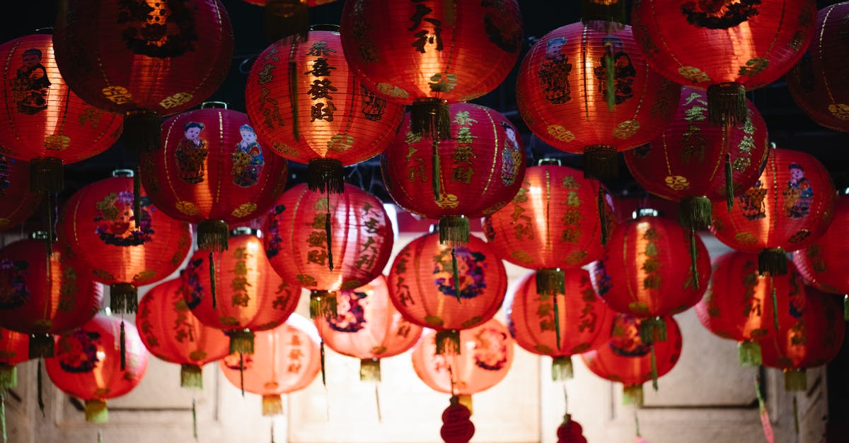 Why are many chinese sauces so dark? - From below of many red rice paper lanterns with golden hieroglyphs hanging on street during celebration of Chinese Spring Festival