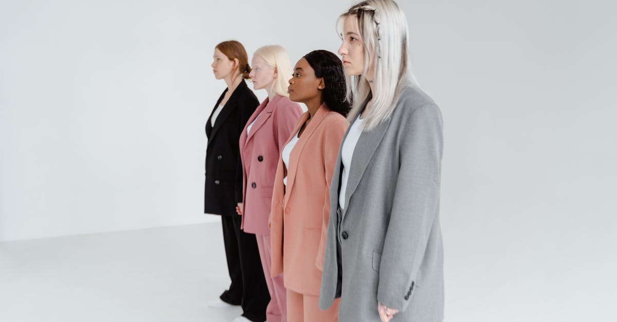 Why are nectarine pits different colors? - Woman in Gray Blazer Standing Beside Woman in Pink Blazer