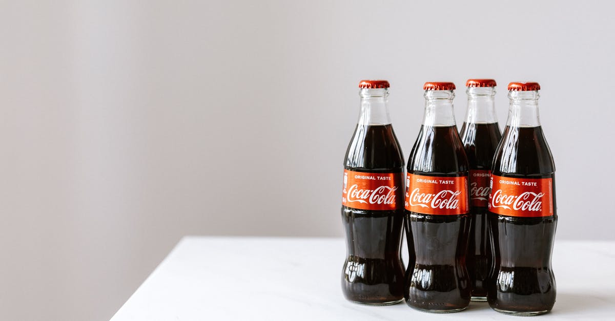 Why boil sugar for lemonade? [duplicate] - Curve shaped glass bottles of cold cola placed on white table against gray background