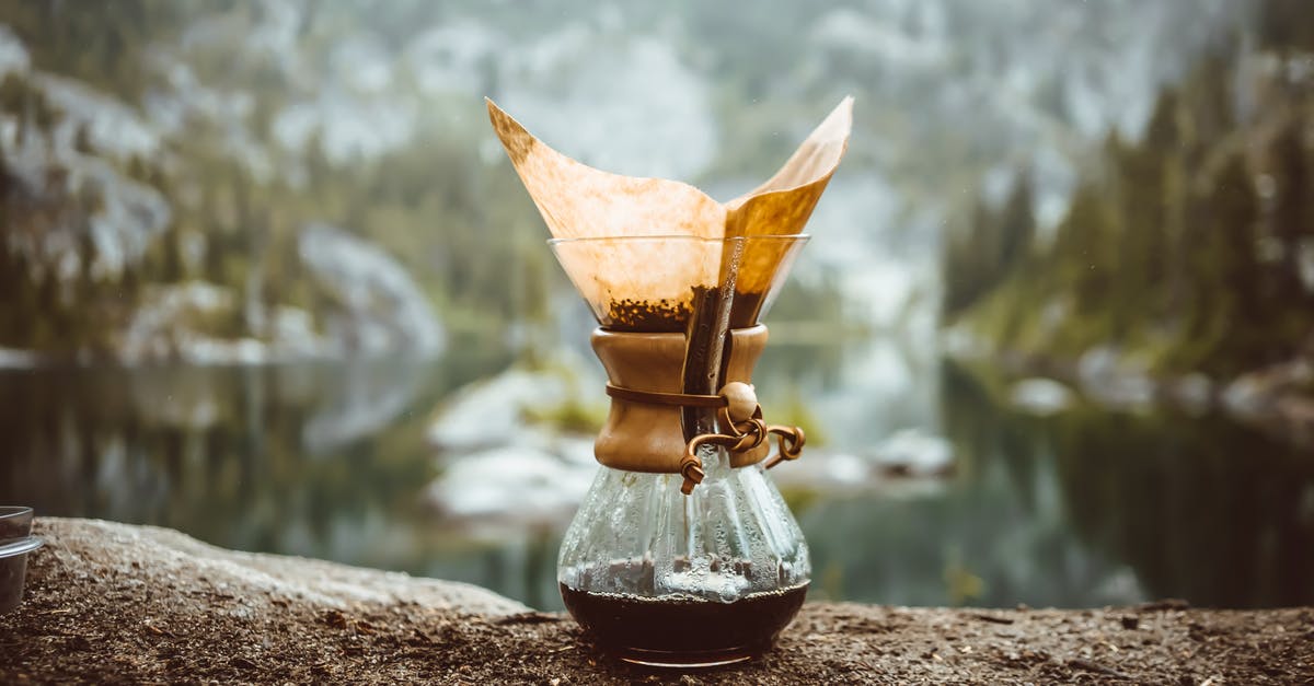 Why brewed coffee in a pot needs a lid? - Chemex pot on rock in mountains