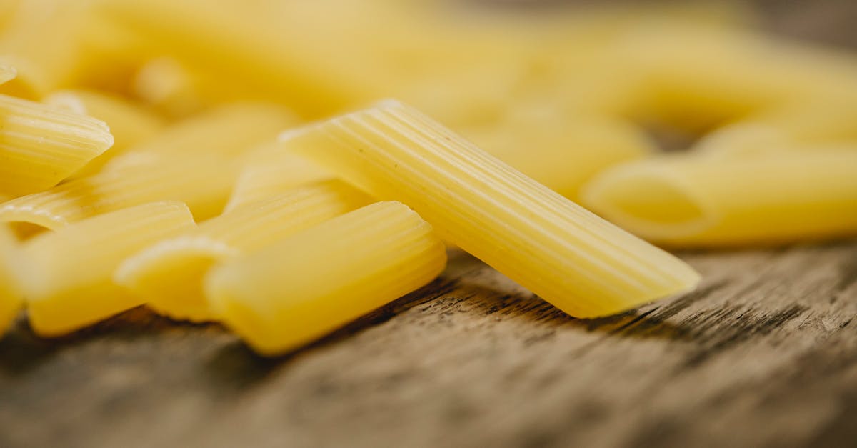 Why can you eat raw oat flour but not raw wheat flour? - Raw penne pasta scattered on table