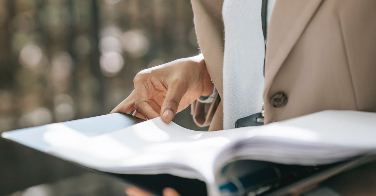 Why did my rum cake turn black? - Crop faceless female entrepreneur in stylish jacket reading important documents in black folder