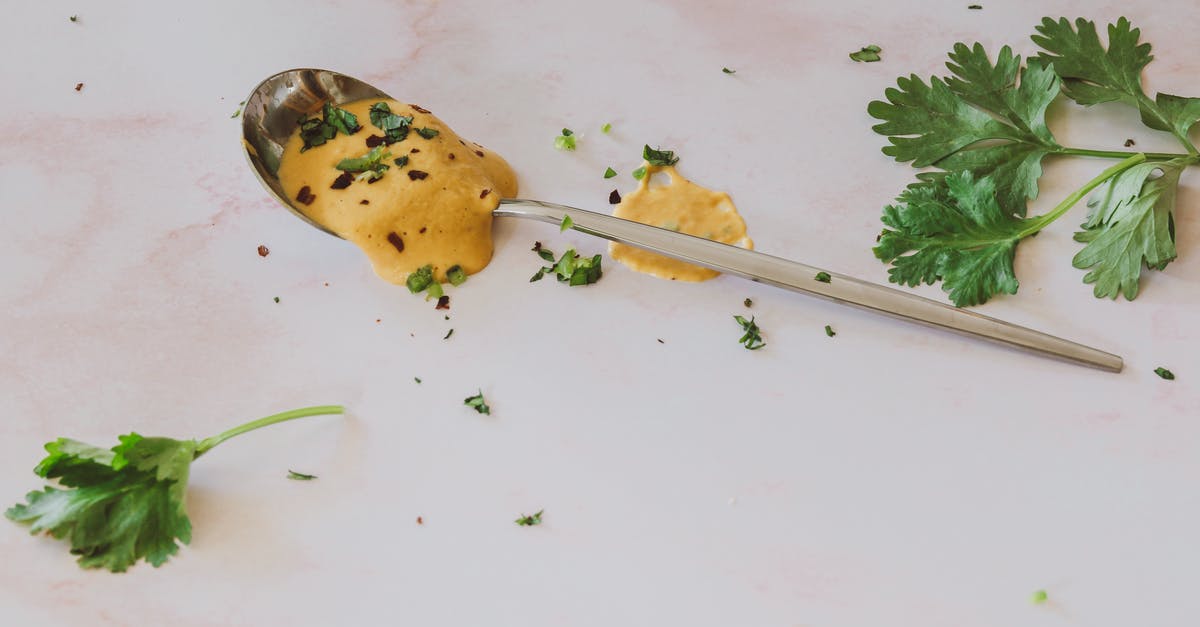 Why did my sauce get lumpy after being frozen? - Stainless Steel Spoon on White Table