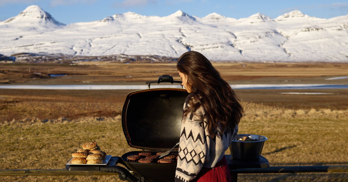 Why do burgers sometimes fall apart on the grill? - Woman cooking meat on grill in countryside