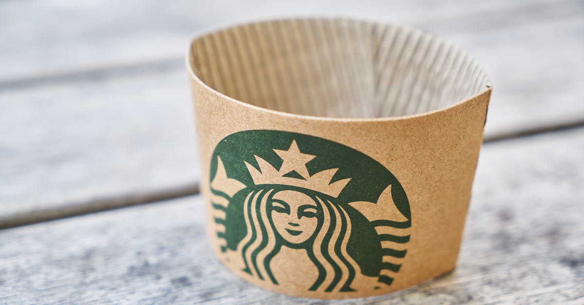 Why do industrial drinks mark caffeine as a flavoring? - Brown Starbucks Paper on Gray Wooden Surface