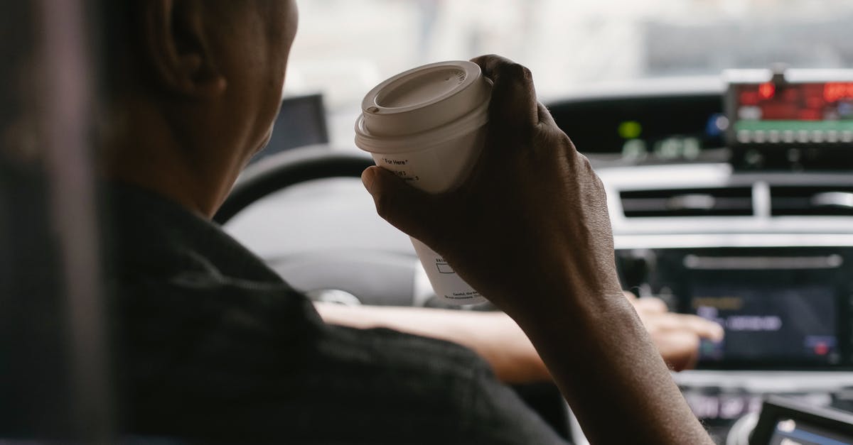 Why do industrial drinks mark caffeine as a flavoring? - Faceless driver drinking coffee while driving car