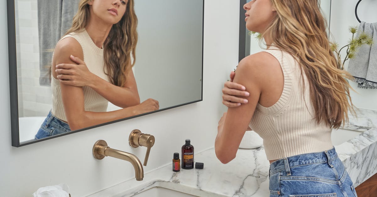 Why do most people in USA use Soyabean cooking oil even when it is refined? [closed] - Woman in White Tank Top and Blue Denim Jeans Standing in Front of Mirror