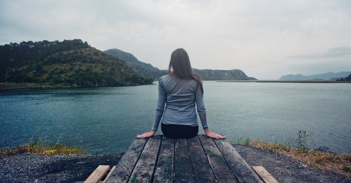 Why do my macarons come out looking weird? - Woman Wearing Gray Long-sleeved Shirt and Black Black Bottoms Outfit Sitting on Gray Wooden Picnic Table Facing Towards Calm Body of Water at Daytime