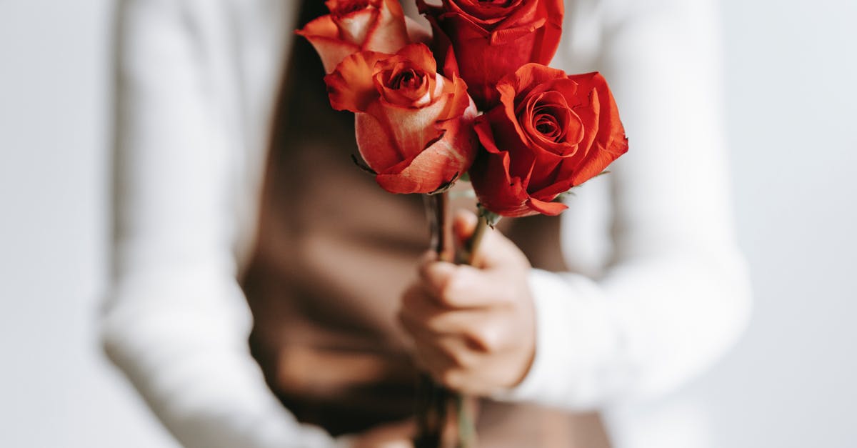 Why do my stored cashews smell like fish? - Woman with branches of roses in hands