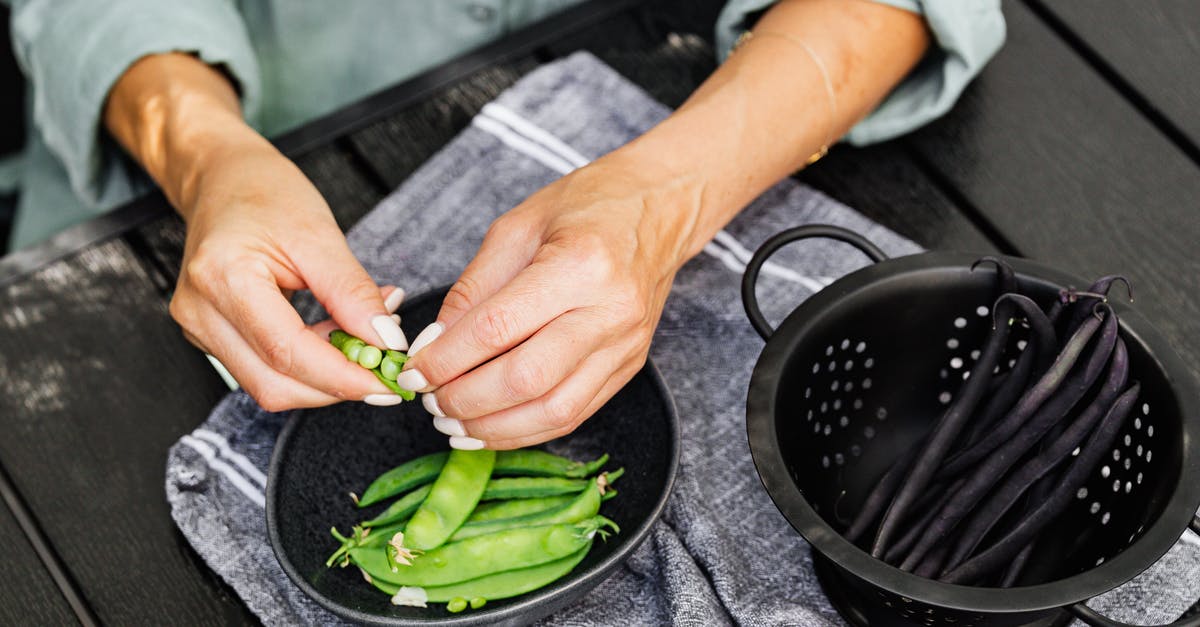 Why do purple snap beans turn green when cooked? - Person Holding Green Vegetable on Black Round Plate