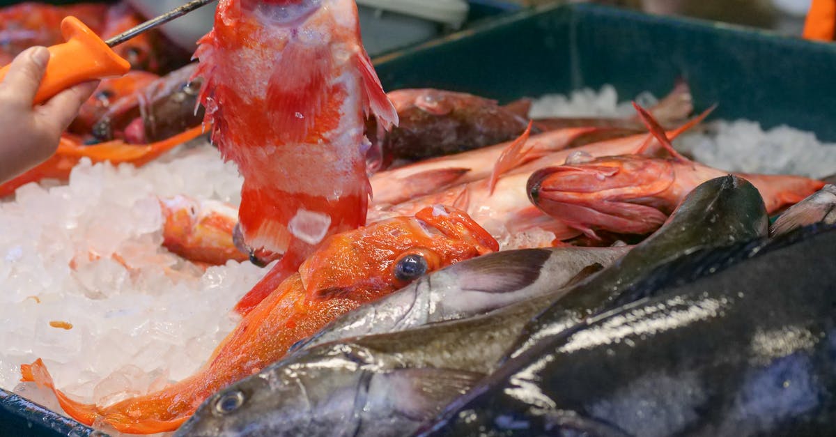 Why do shrimp / lobster / crab turn pink or red when cooking? - Silver Fishes on White Plastic Container