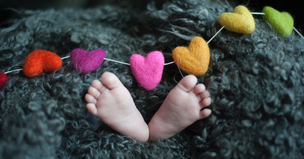 Why do some melons contain removeable dark tiny bits? - Baby's Feet Covered With Black Wool Textile