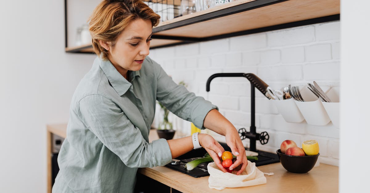 Why do they put the fruit on the bottom? - Woman in Gray Long Sleeve Shirt Holding Green Vegetable