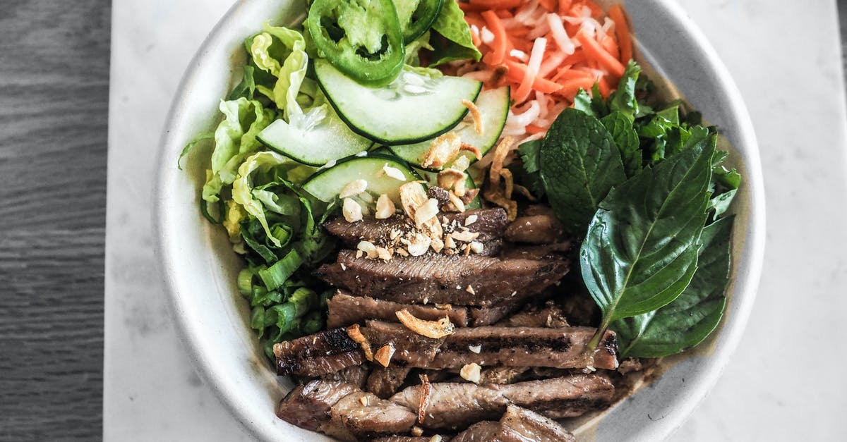 Why do Vietnamese dishes feature cut-up meat with the bone in? - Bowl of Sliced Vegetables and Meat