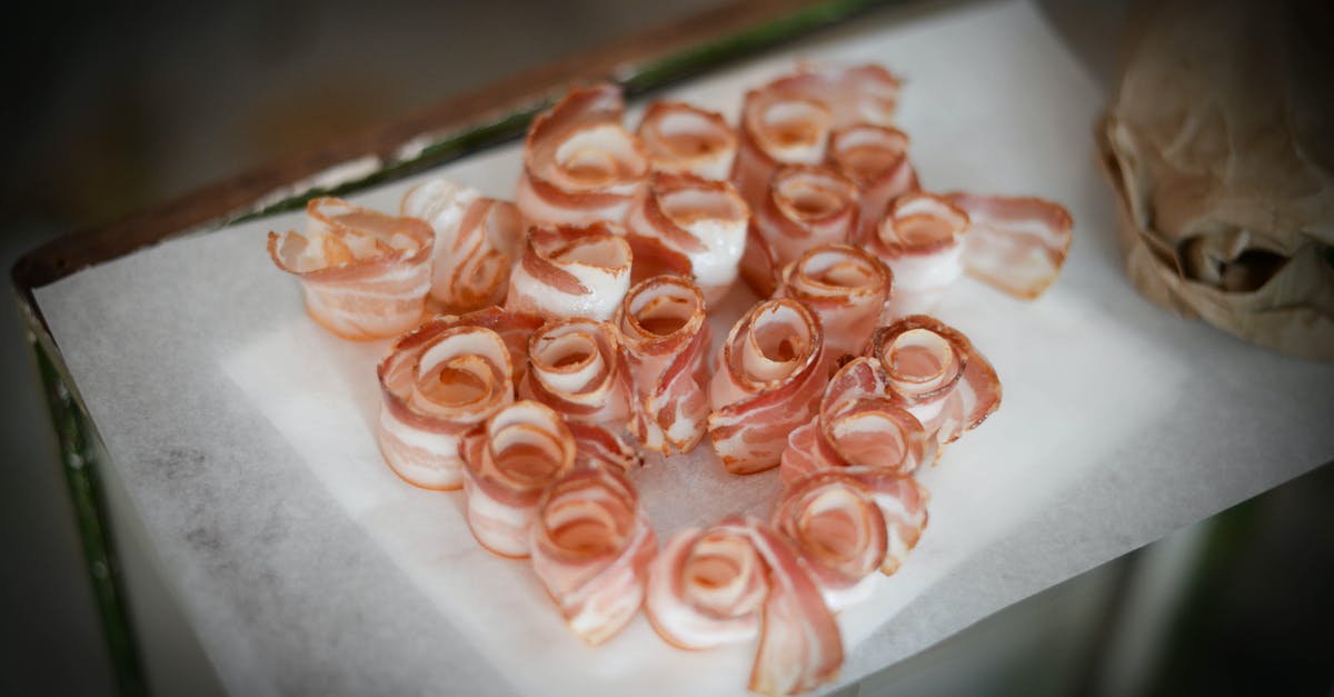 Why do we slice some meats thinly and not others? - Delicious bacon slices on napkin on table