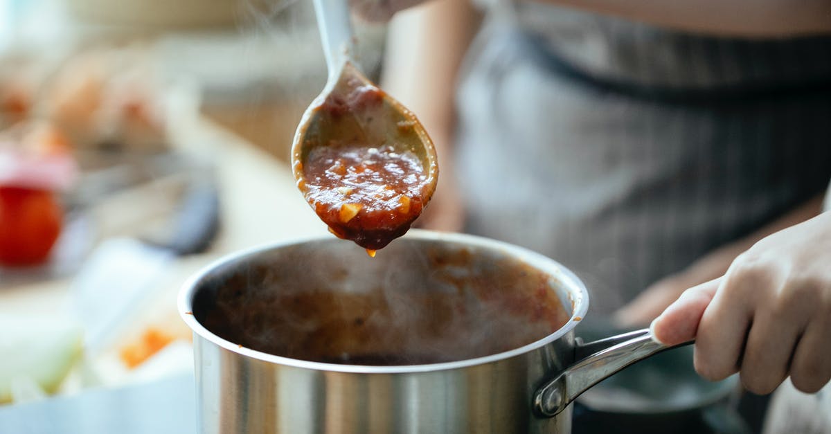 Why do you stir italian sauce all day - Crop women cooking sauce together