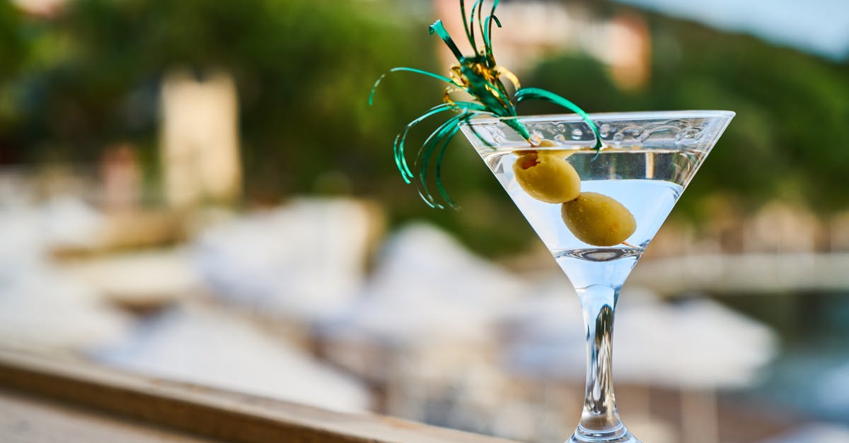 Why does a (vodka) martini often come with an olive on a stick? - Close-Up Photo of Martini With Olives