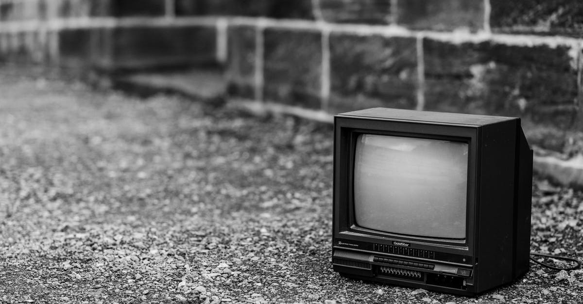 Why does Black Gram Batter turn fluffy only when stone ground? - Black and white of old fashioned television placed on pathway near stone fence in city on street on blurred background