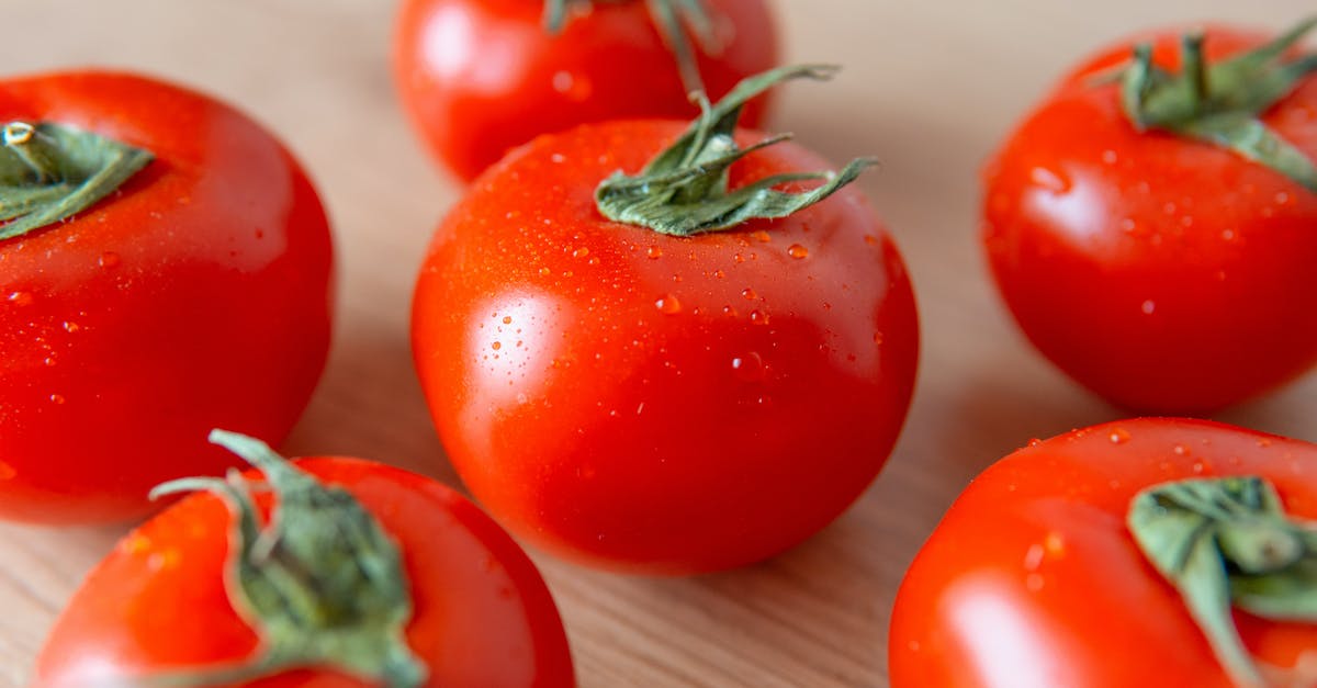 Why does Brining help food to retain water, but adding salt will draw the moisture out? - Close-Up Photo of Tomatoes