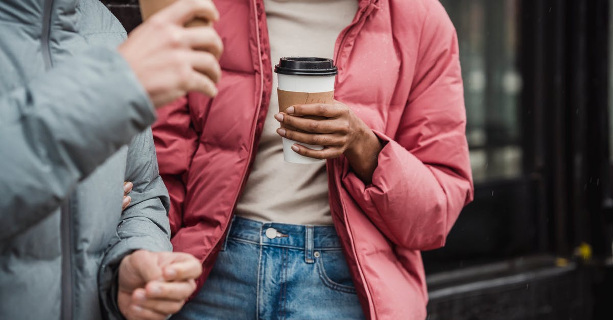 Why does caffeine taste bitter when added to tea? - Crop couple with takeaway coffee