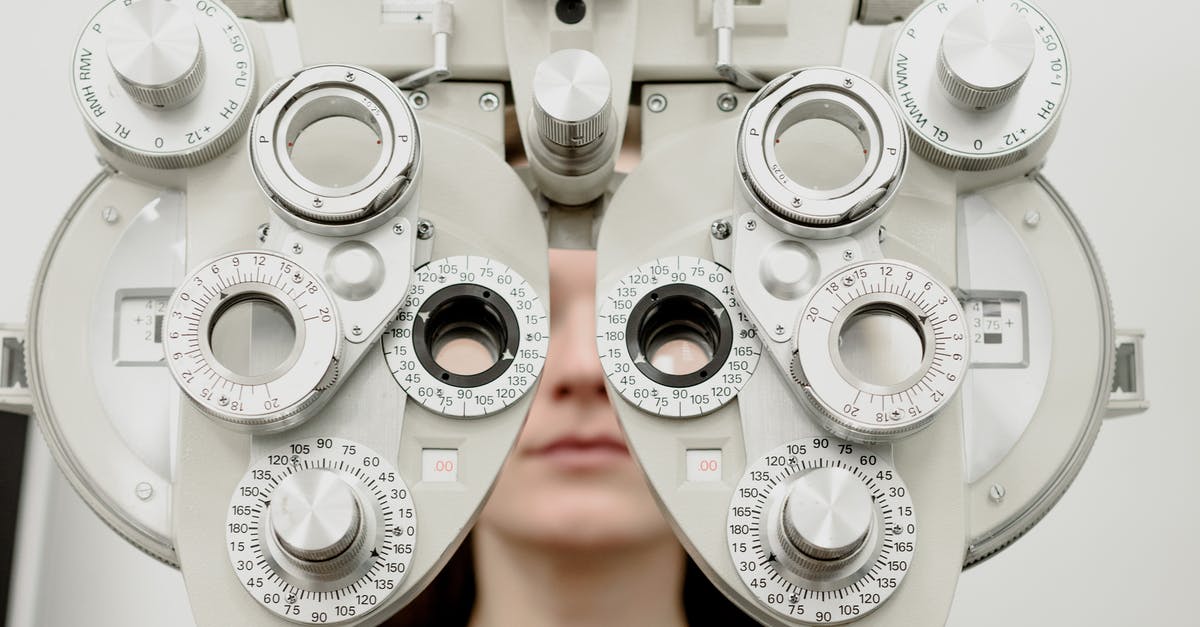 Why does chilled equipment help when whipping cream? - Woman diagnosing vision on refractor testing device during eye examination in modern ophthalmology clinic