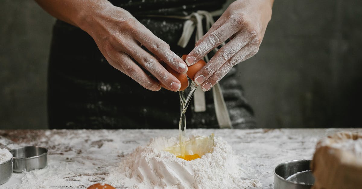 Why does dough break when kneading, and how to prevent/ameliorate it? - Person breaking egg to flour for pastry