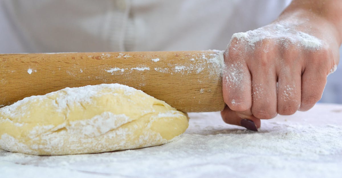Why does dough break when kneading, and how to prevent/ameliorate it? - Person Holding Dough With White Powder