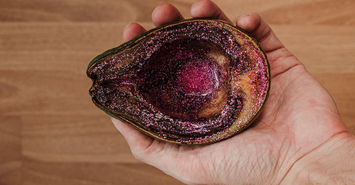 Why does food spoil in the freezer? - Man showing rotten avocado with pink glitter