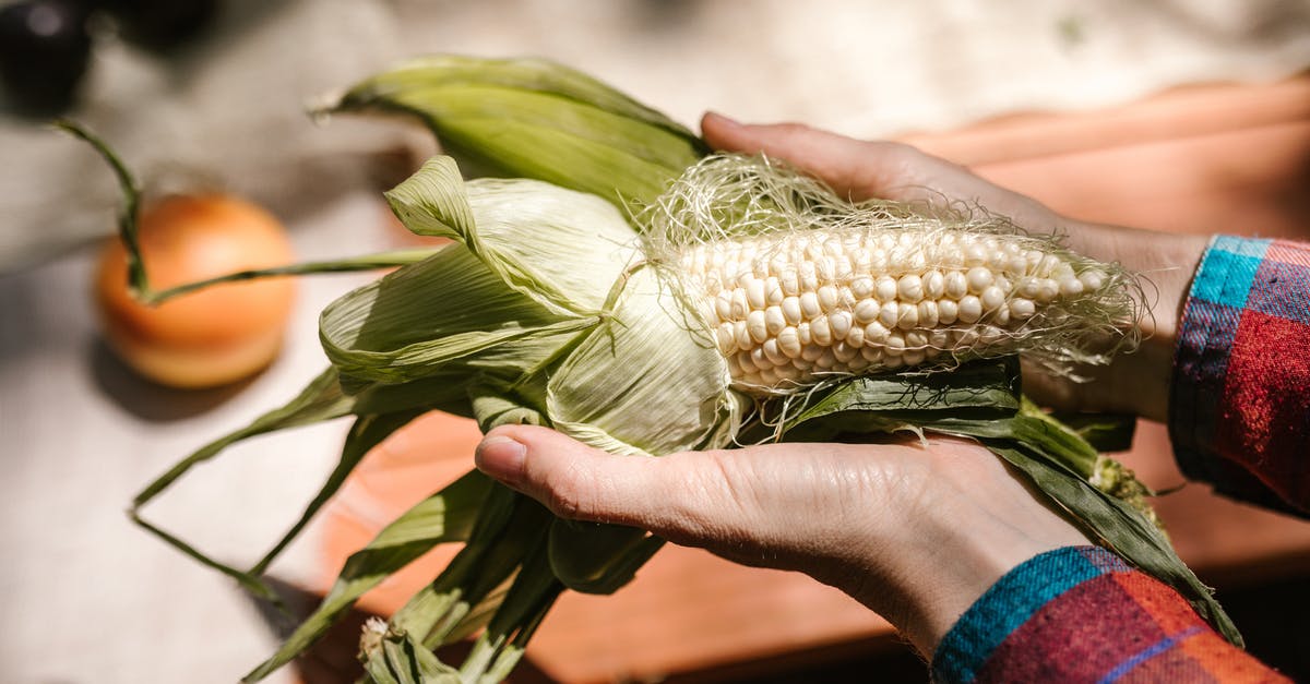 Why does handling peeled chayote make your hands feel numb/rigid? - Person Holding a Peeled Corn