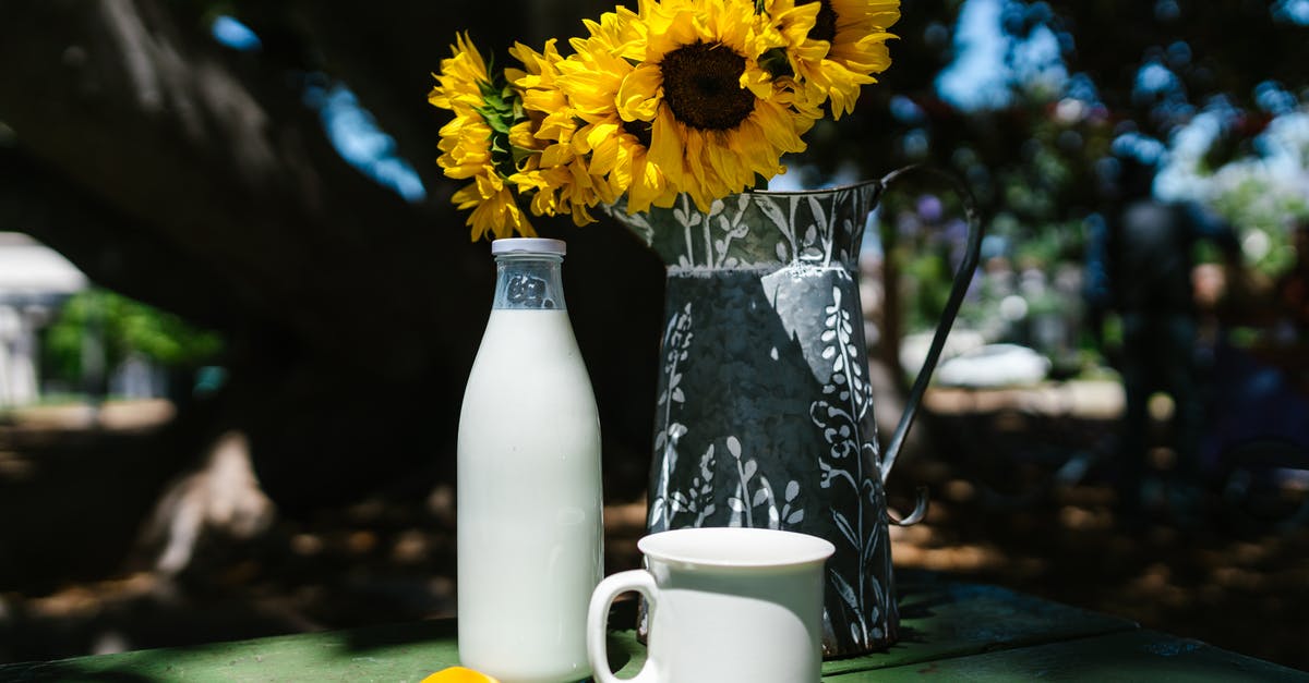 Why does milk turn yellow in a silver glass? - Yellow Flowers in a Vase Near Milk Bottle