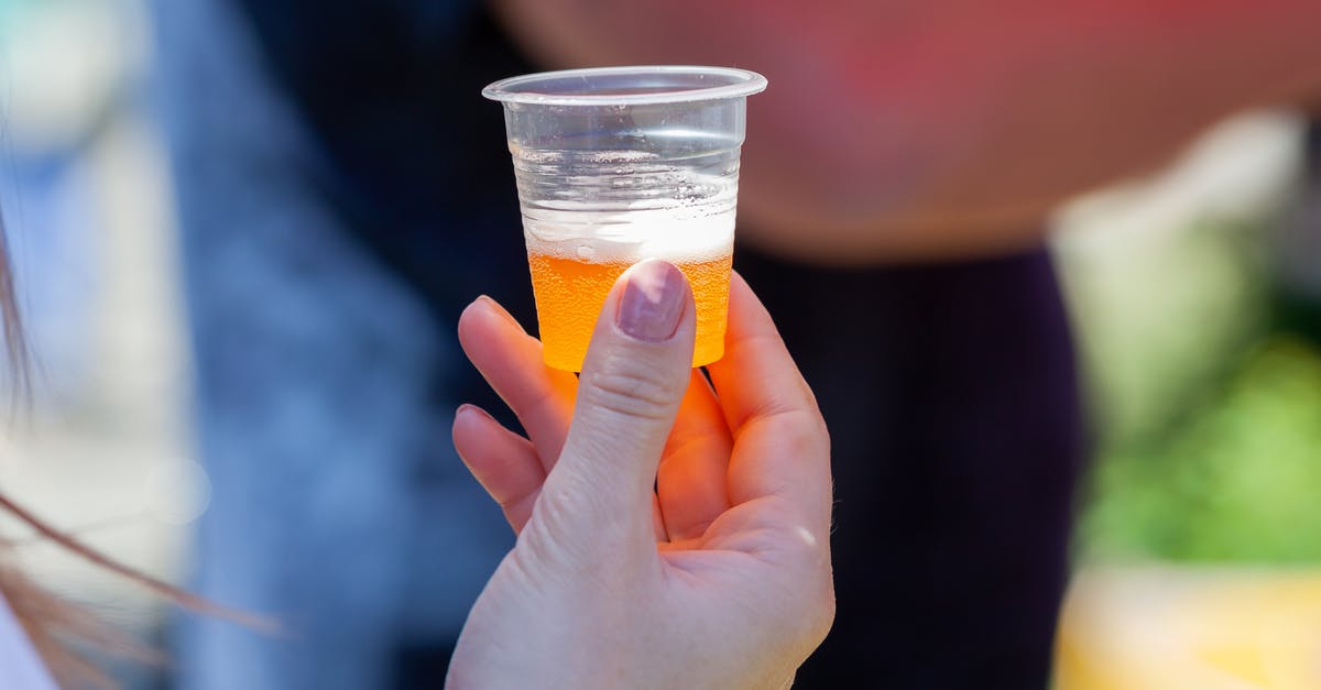 why does my beer batter seem to hold too much oil? - A Person Holding a Plastic Cup with Beer