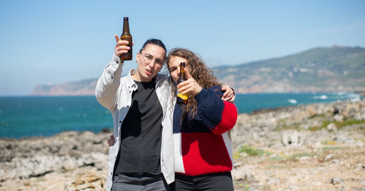 why does my beer batter seem to hold too much oil? - Photo of a Couple Holding Bottles of Beer