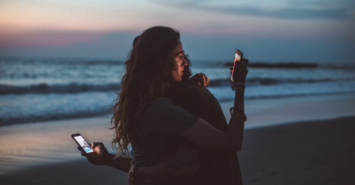 Why does my skillet burn even when using peanut oil? - Couple hugging and using smartphone near sea on sunset