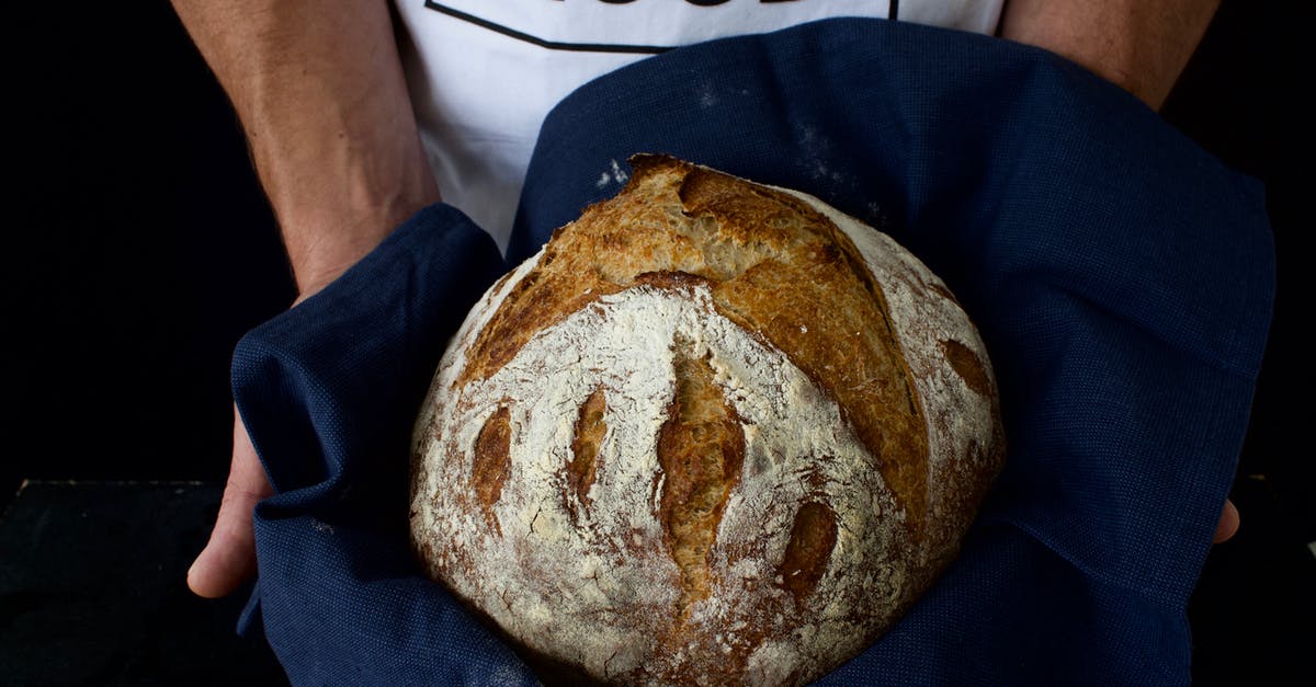 why does my sourdough bread have lumps of flour - Person Holding a Sourdough Bread