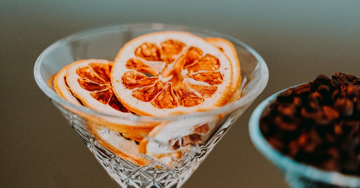 Why does peanutbutter become dry when mixed with orange zest and juice? - Colorful slices of citrus in conical transparent festive glass in daylight on blurred background