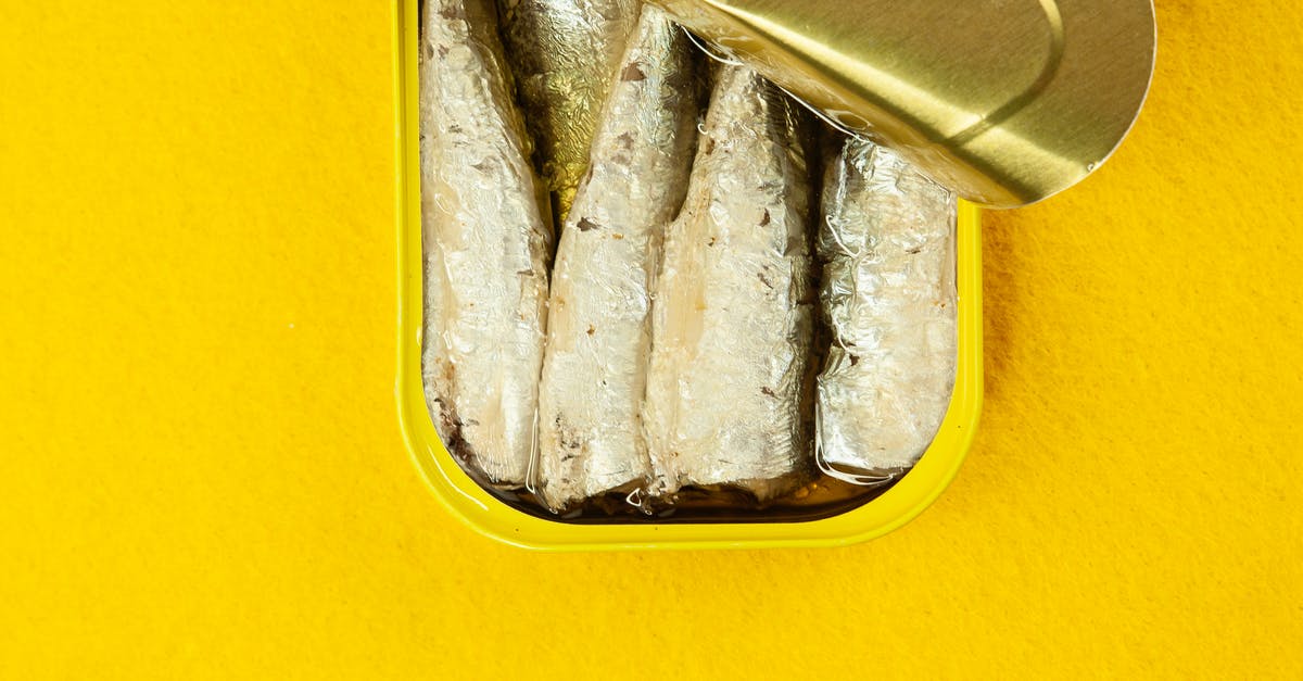 Why does processed meat contain preservatives, while canned fish needs not? - Canned fish in yellow container