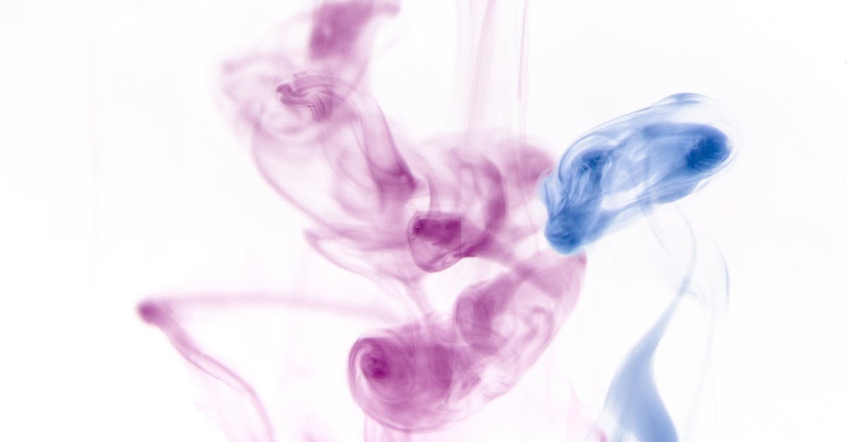 Why does spatzle dissolve in water? - Closeup of blue and purple coloured light swirling transparent smoke on white background
