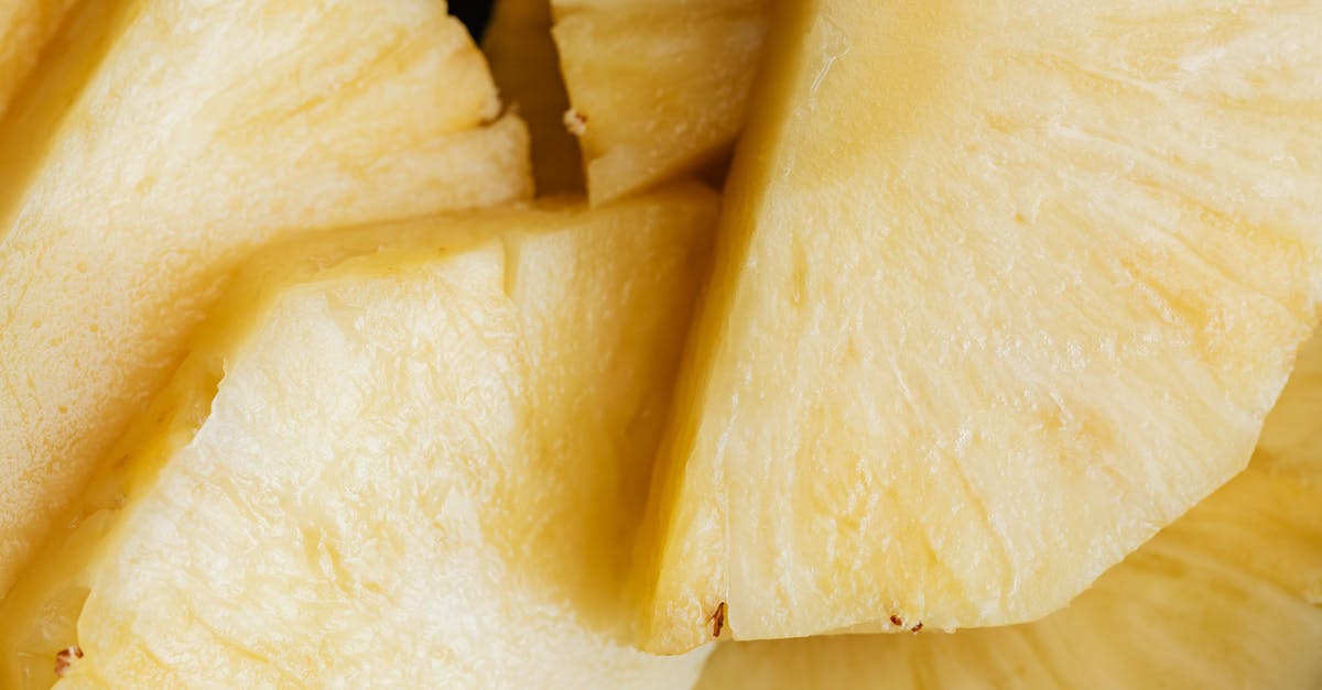 Why does the pineapple always ripen/soften from the base? - Top view closeup background of yellow ripe fresh sliced pineapple placed on top of each other