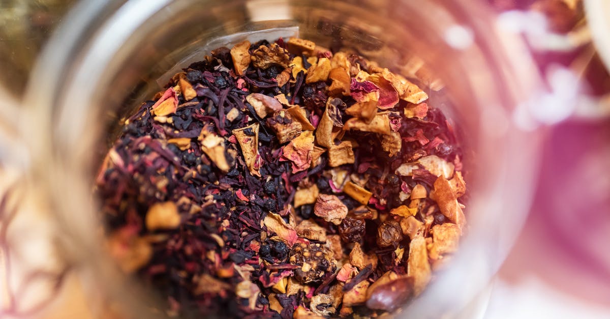 Why does this homemade herbal tea always boil over? - From above of glass jar with dry aromatic fruit tea against blurred background in daylight