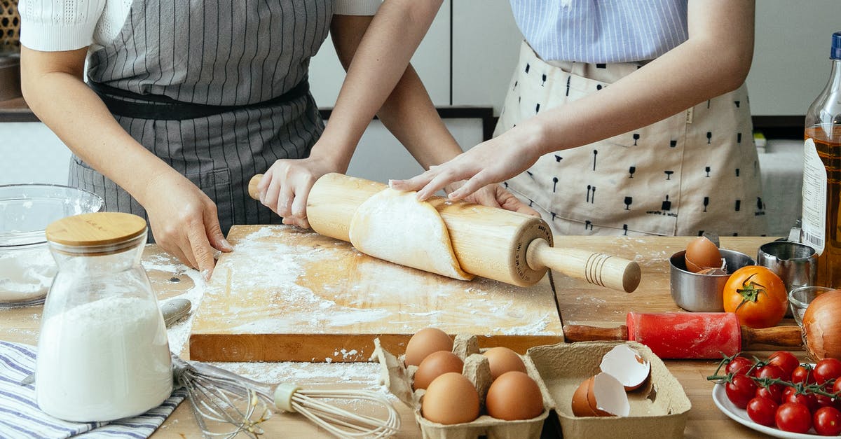 Why does tomato not dissolve when I make curry - Crop women rolling dough on board