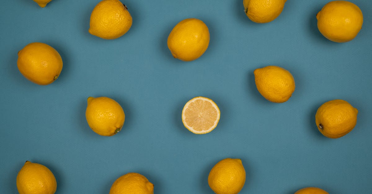 Why does unpeeled fruit rot? - Fresh lemons with juicy flesh on blue background