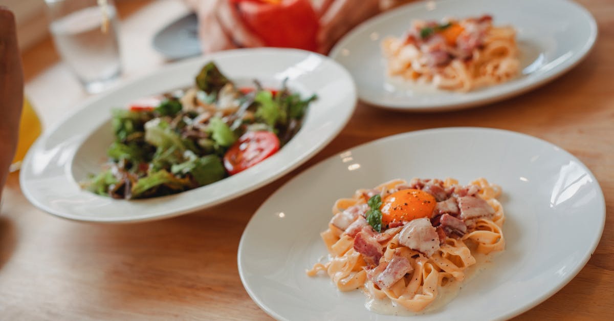 Why does white vinegar taste better when at restaurants? - Delicious pasta and salad on table