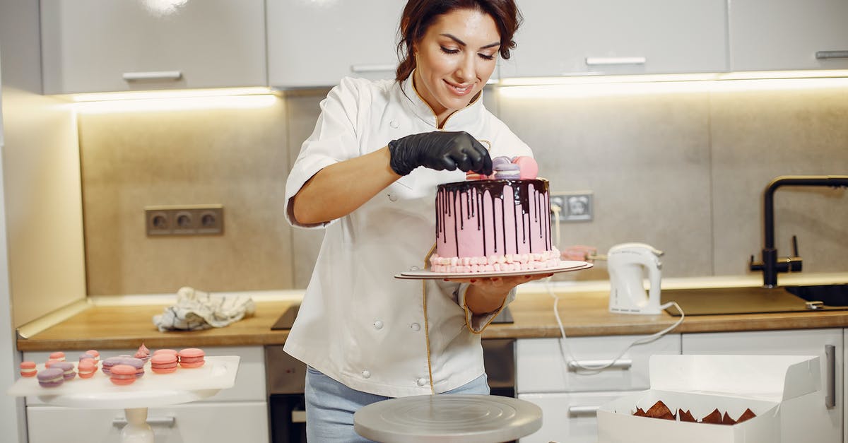 Why doesn't my cookie recipe work in the US? - Smiling female cook decorating cake with delicious macaroons in modern restaurant