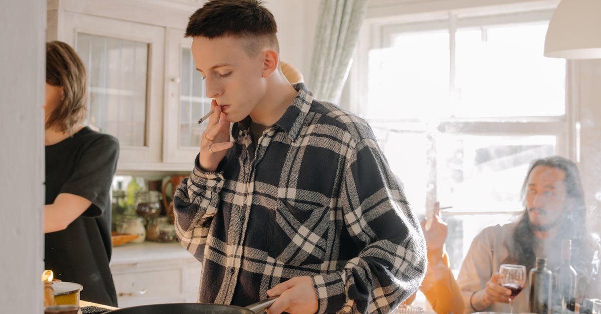 Why have all of my quality pans started smoking at once? - Man in Black and White Plaid Dress Shirt Holding Chopsticks