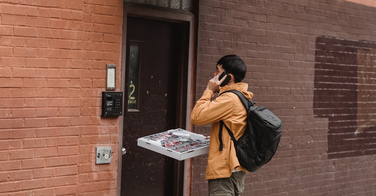 Why is delivered pizza often oily? - Man Standing Beside a Door