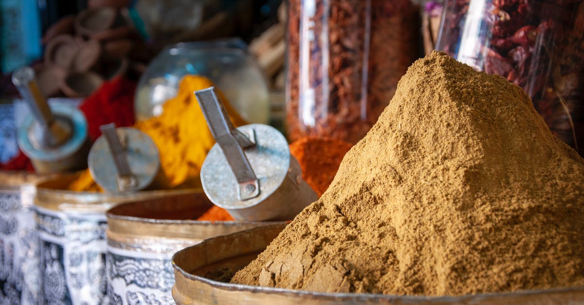 Why is garam masala in many curry paste/powder recipes? - Various colorful spices in local market on sunny day