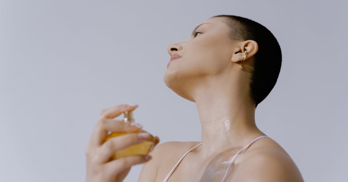 Why is Ginger essence hard to get hold of? - Woman Spraying Perfume on Her Neck